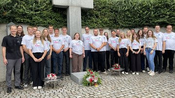 Gruppe junger Menschen an einem Hochkreuz